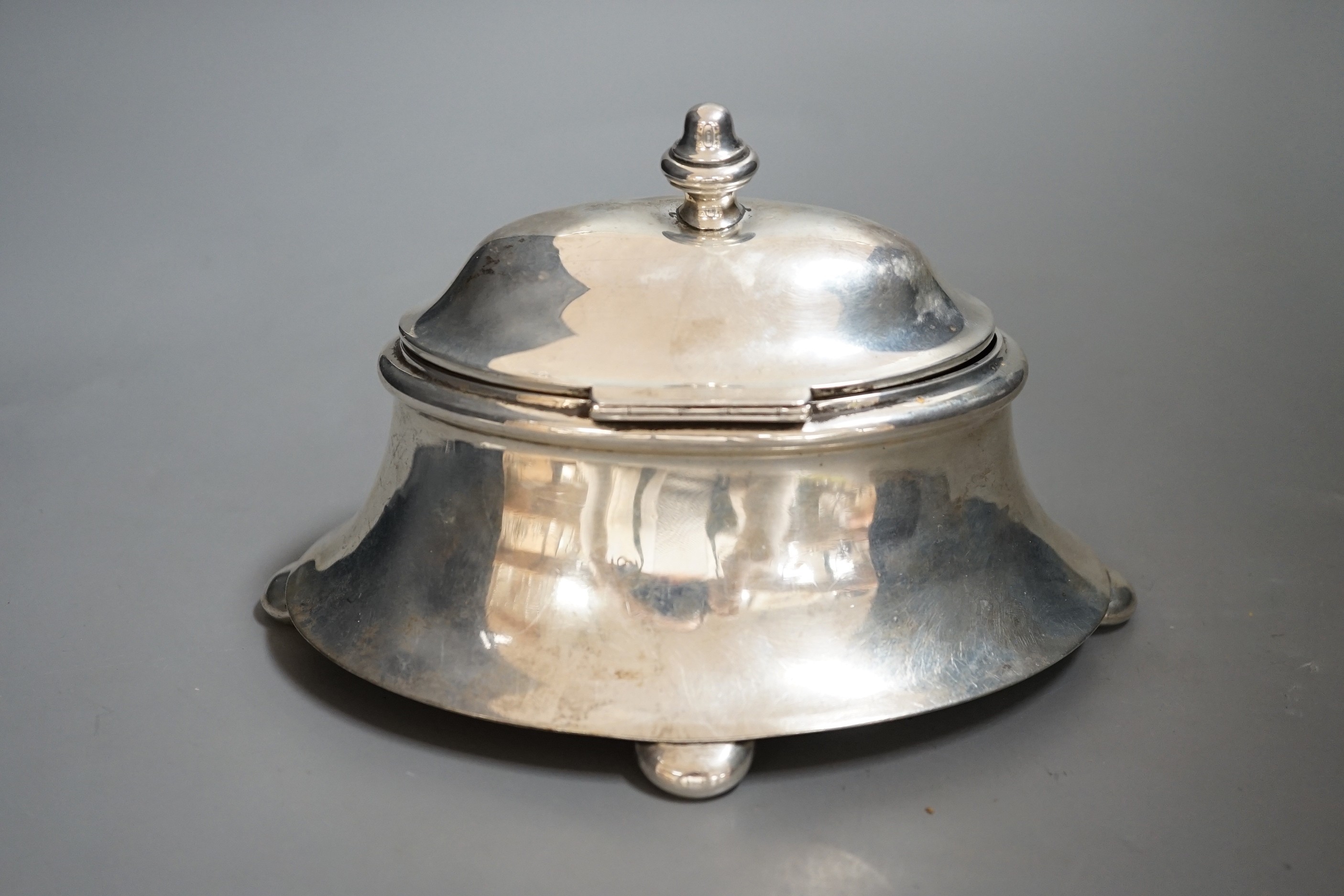 An early 20th century silver oval box, with hinged cover, on bun feet marks rubbed, length 18.5cm